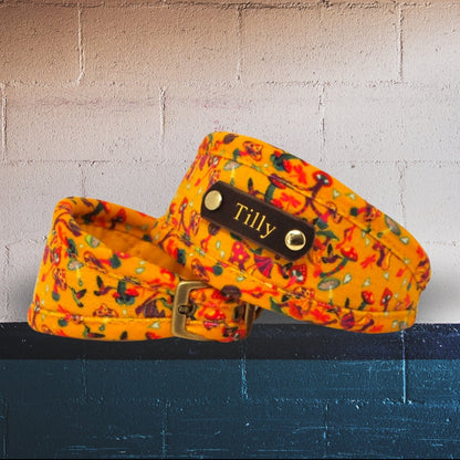 A designer dog collar with a vivid amber yellow theme featuring a pattern of magic mushrooms, birds, dragonflies, and hearts in multiple colors. Whippets, sighthounds greyhound collar, or slim fit. Optional name plate to add dogs name